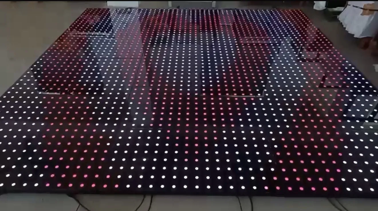 LED infinity mirror dance floor lit with rows of red, pink, and white dots