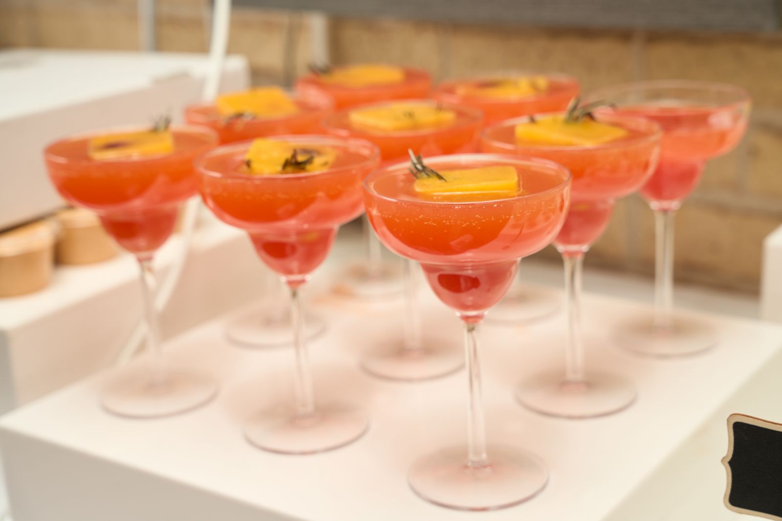 Sip by CB mocktail bar dressed with glassware and garnishes for an event.